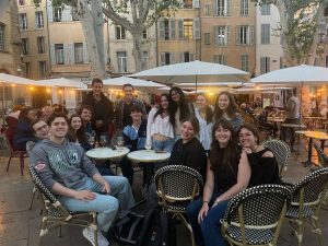 Group of students dining at an outdoor restaurant located in Paris.